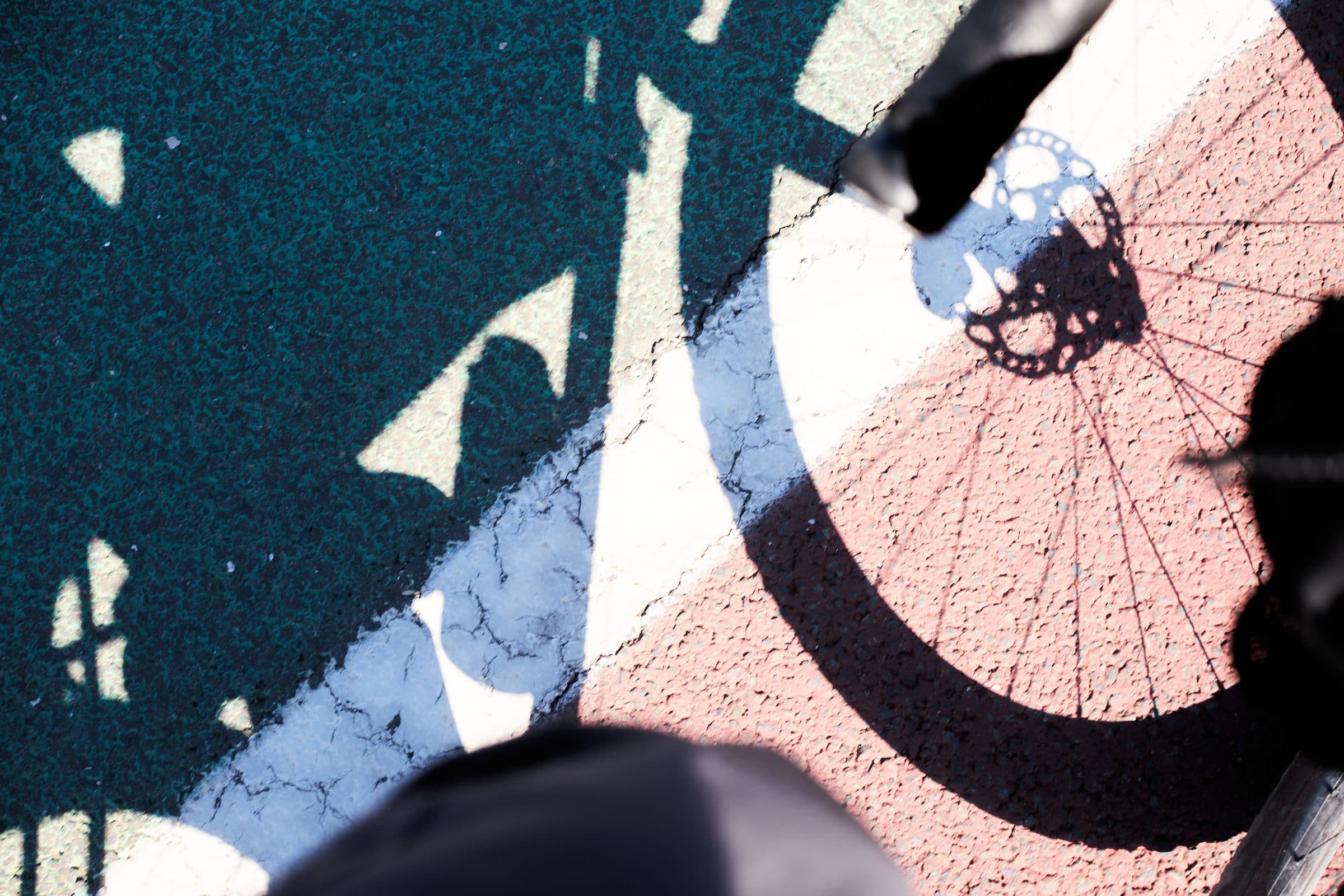 The shadow of a HiFi wheel on a painted road in Spain.