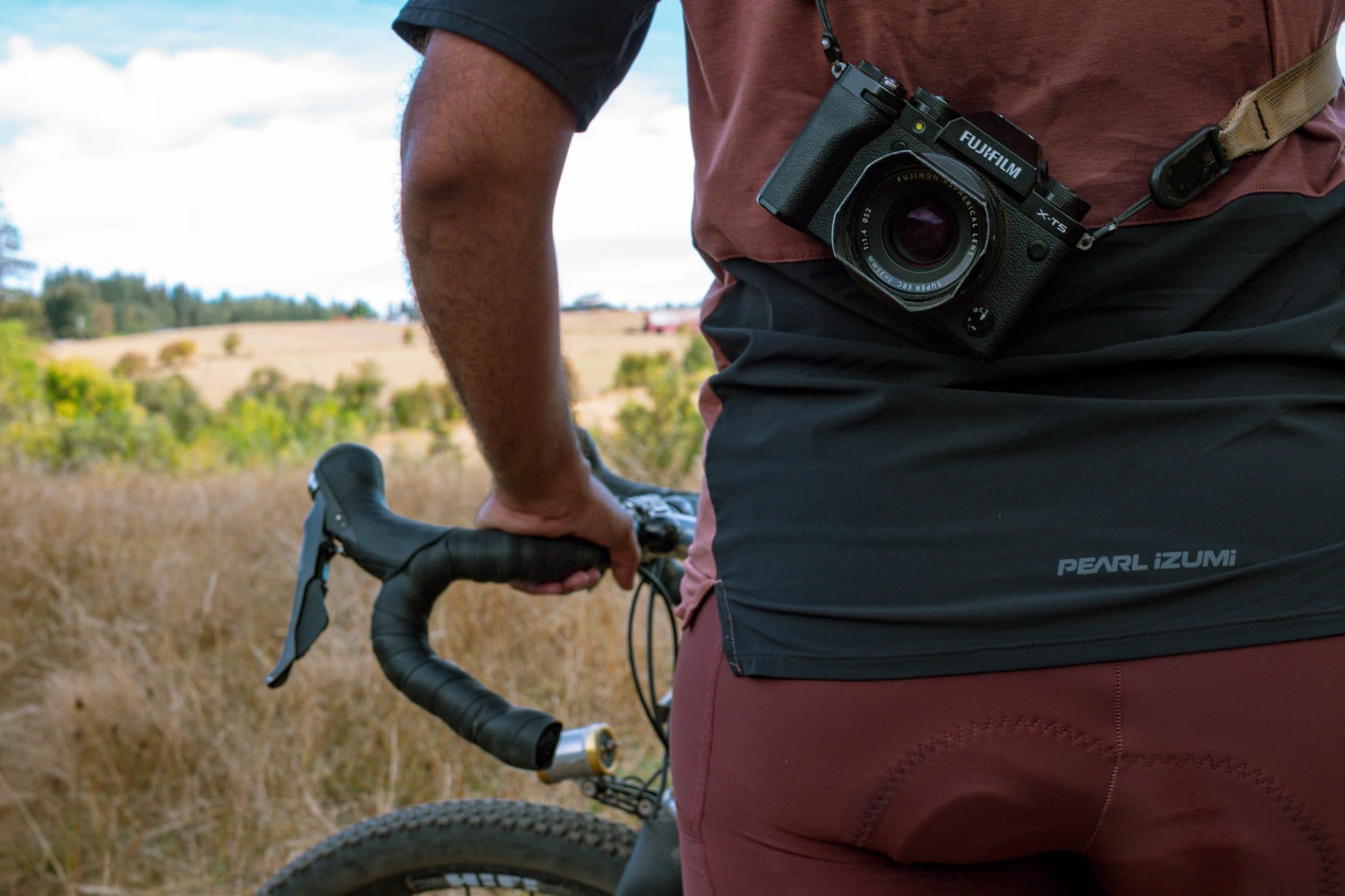 Camera slung at the hip over the bib cargo pocket.