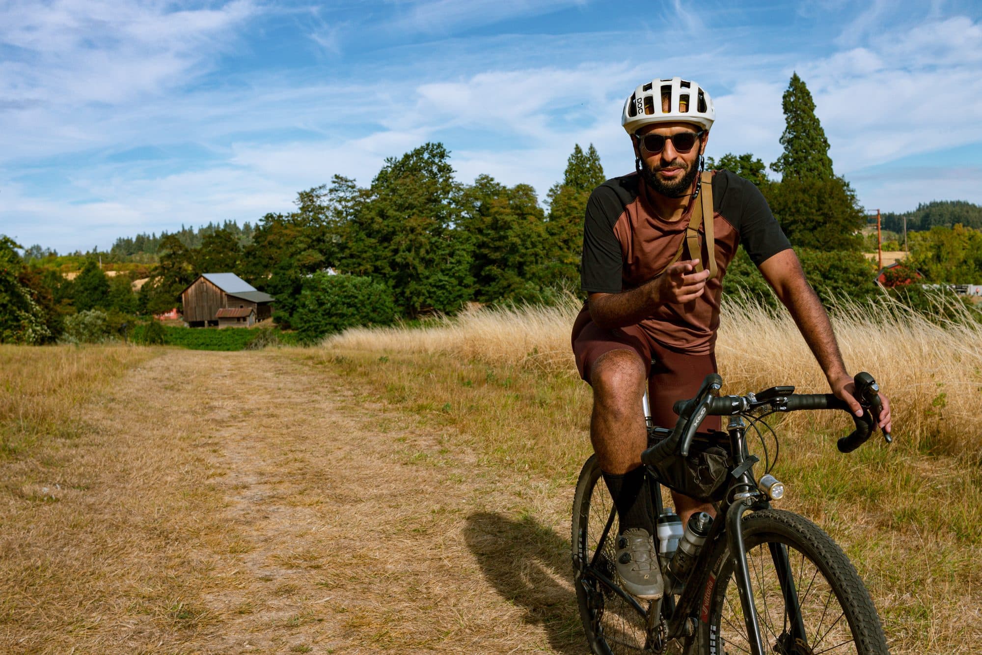 Riding toward camera on a grassy farm track.