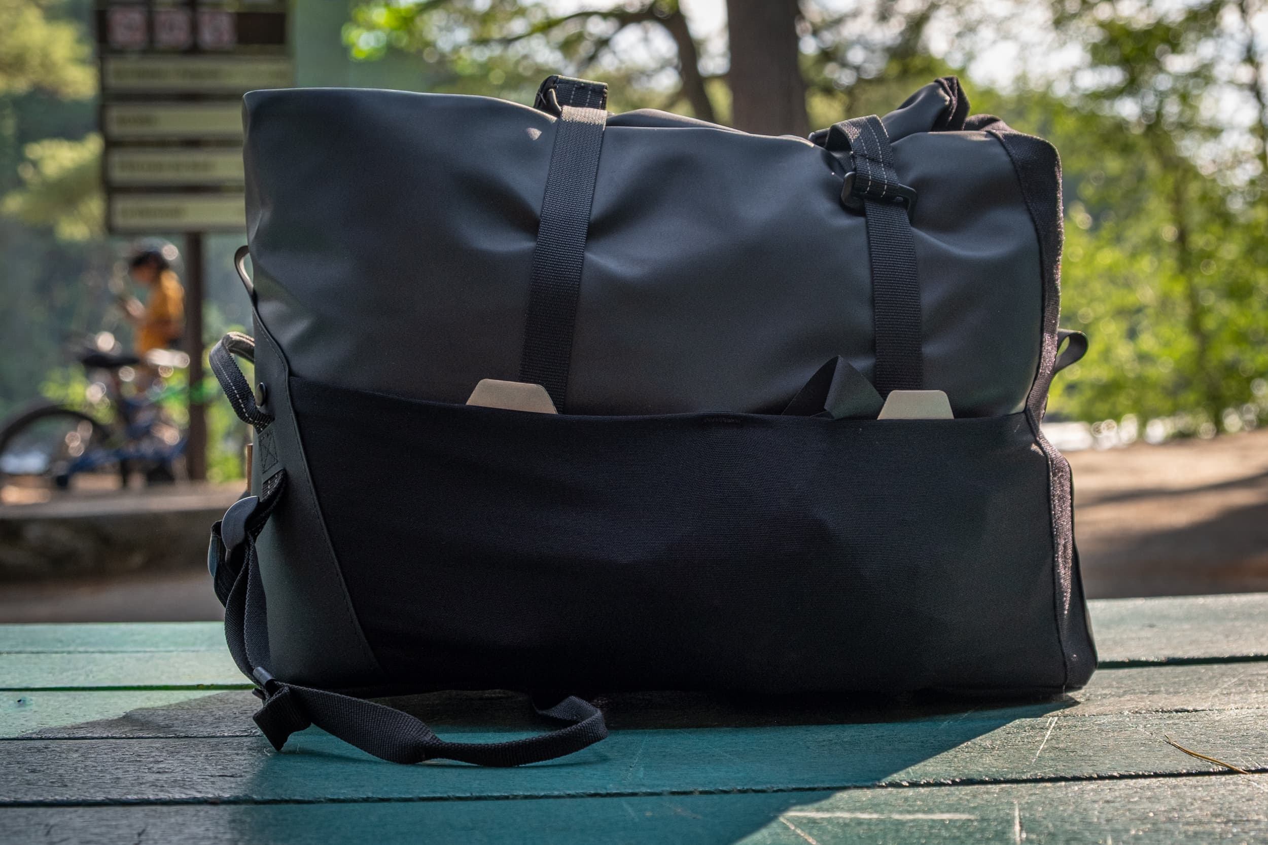 The Switch Top Bag's donut keychain hanging off the rack at a trailside picnic table.