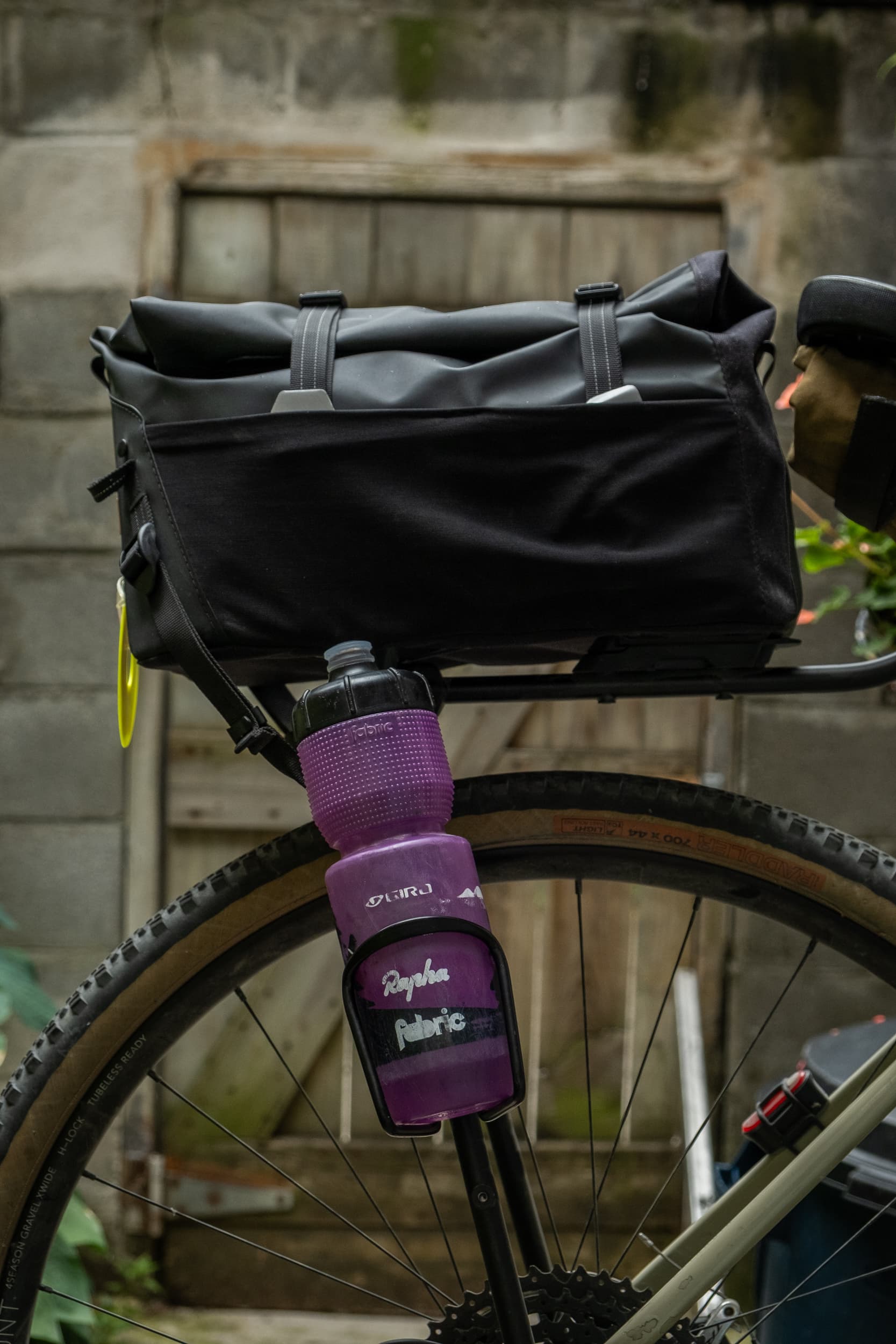 Switch Top Bag mounted with a water bottle cage on the rack leg.