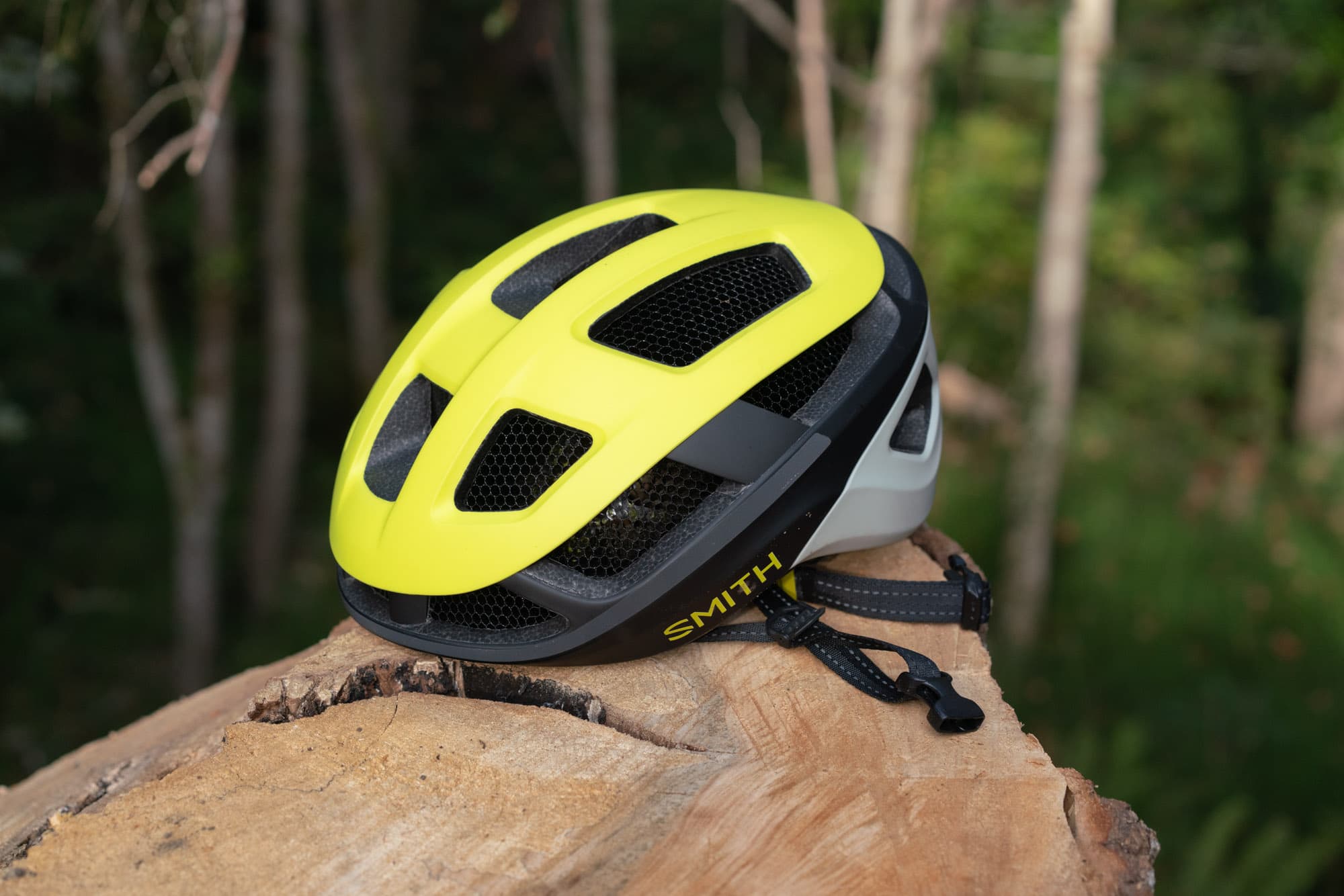 The Smith Trace resting on a log, showing its vent channels and high-vis top.