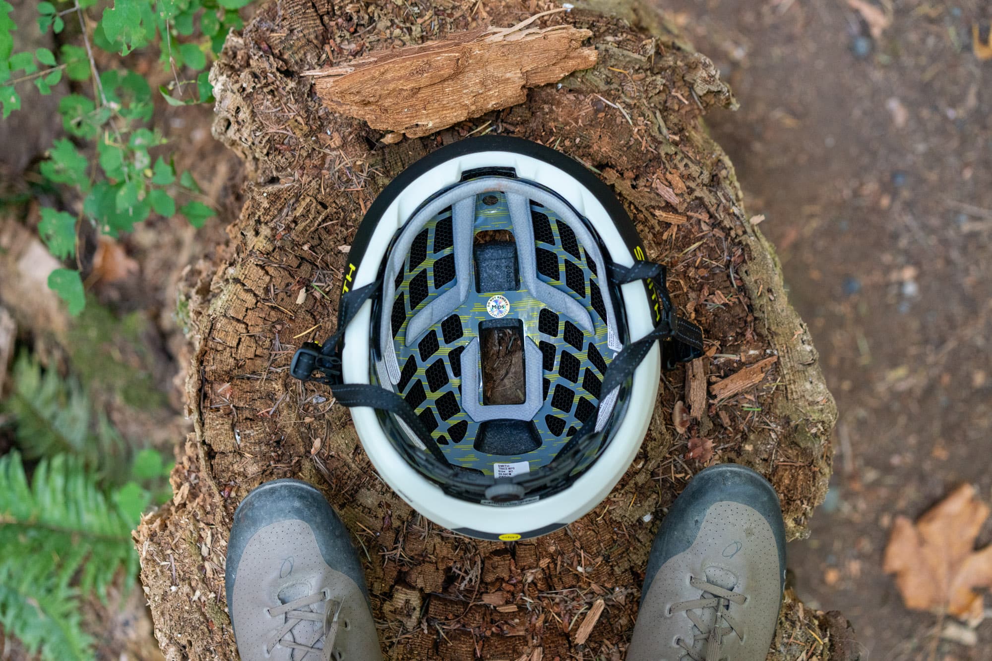 Inside the Smith Trace, showing the MIPS liner, Koroyd, and pads, between Barry's shoes.