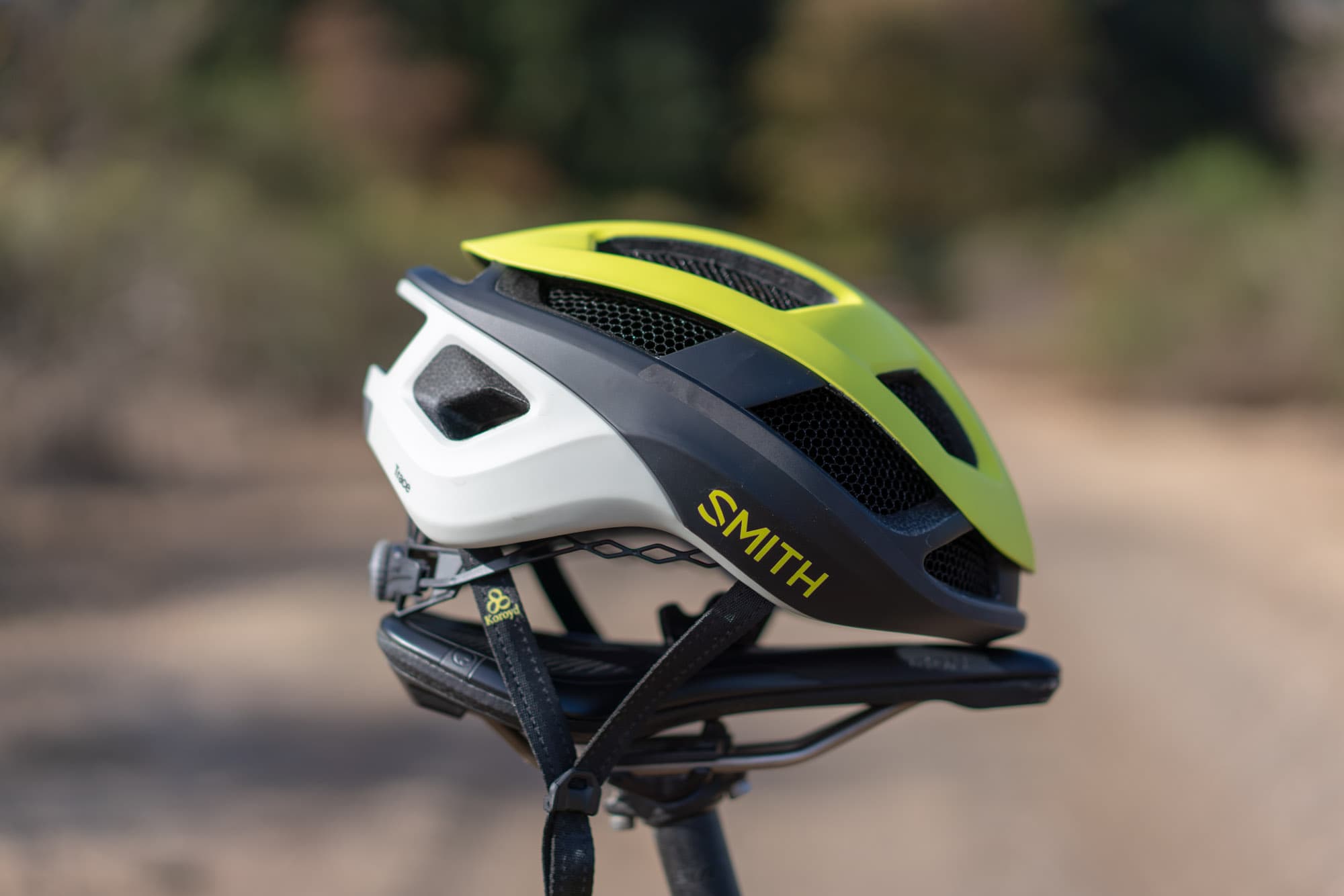 The Smith Trace perched on a bike saddle beside a gravel road.