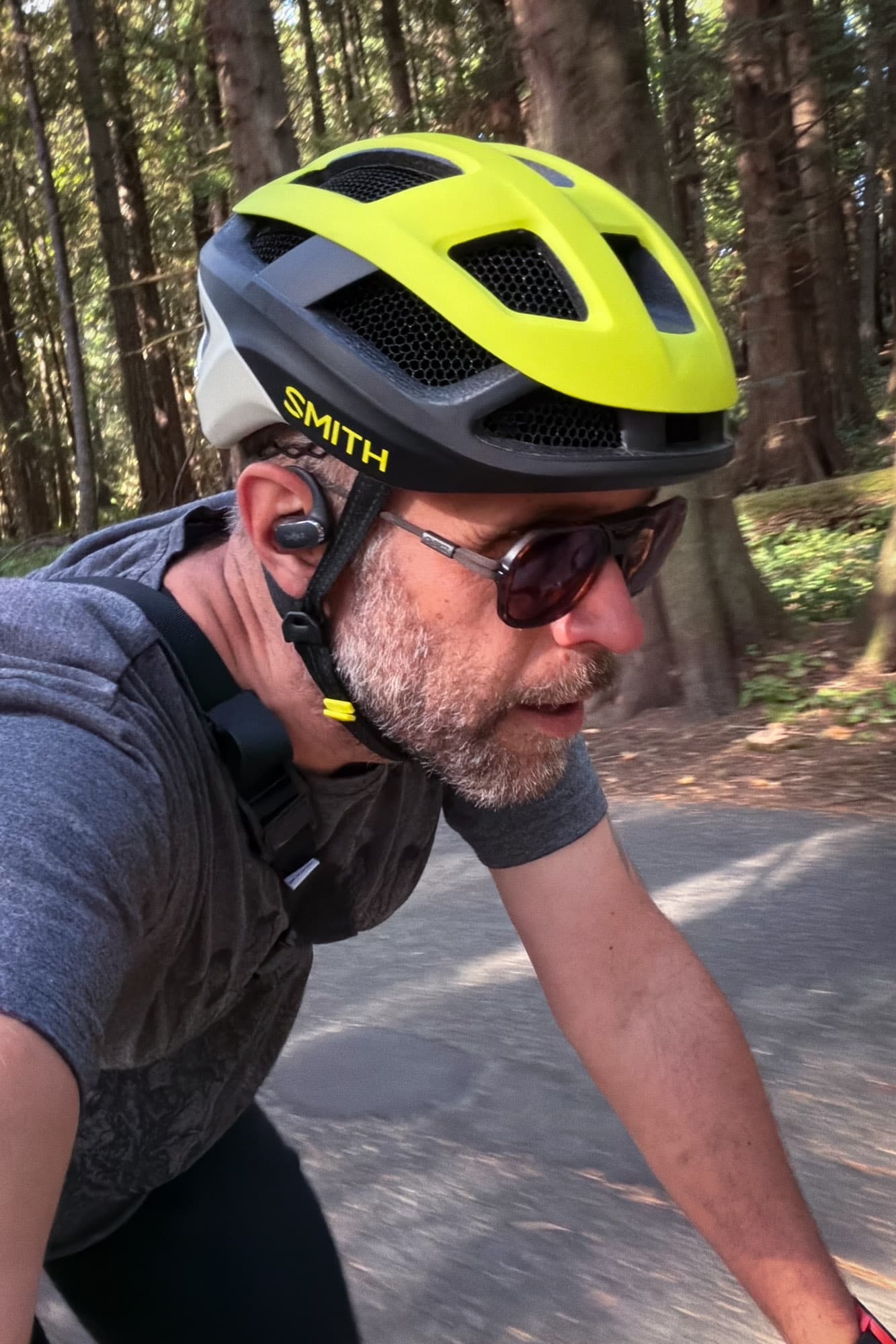 Barry riding a paved road through the trees in the Smith Trace.