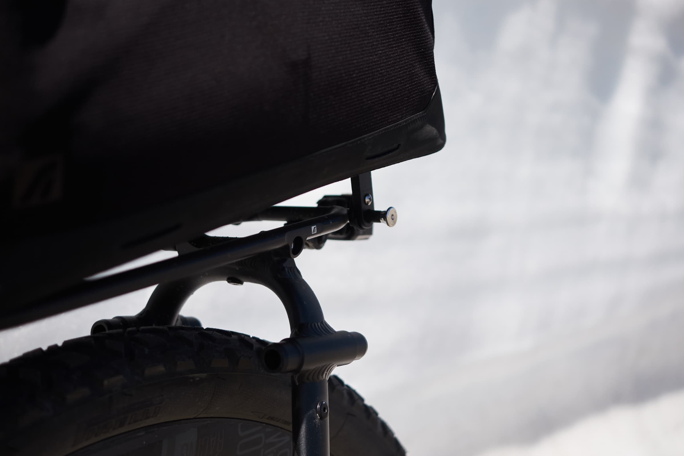 Close-up of the rack's arch mount against a snowy backdrop.