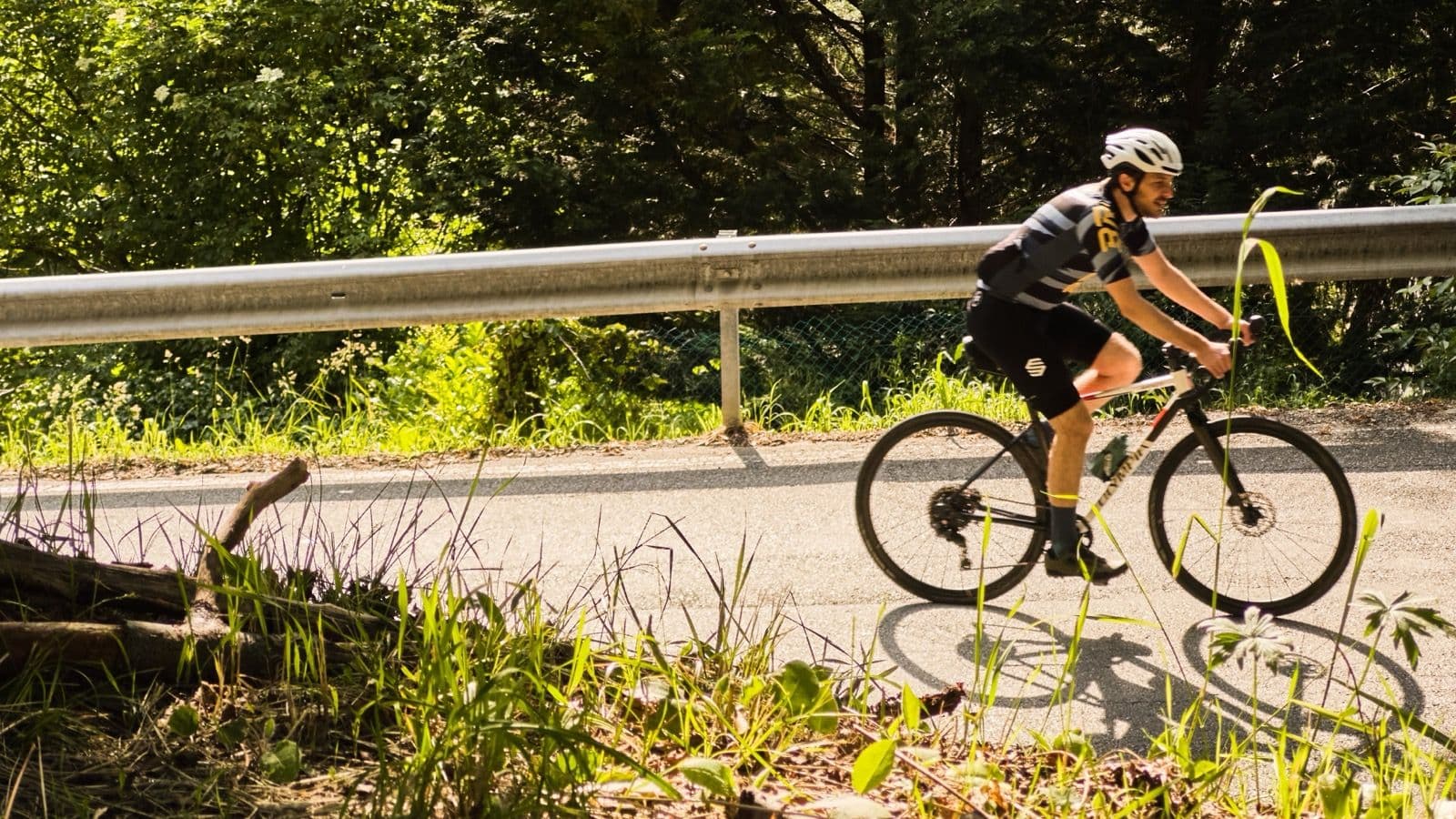 A rider climbing the Panoramica above Turin, backlit by low sun