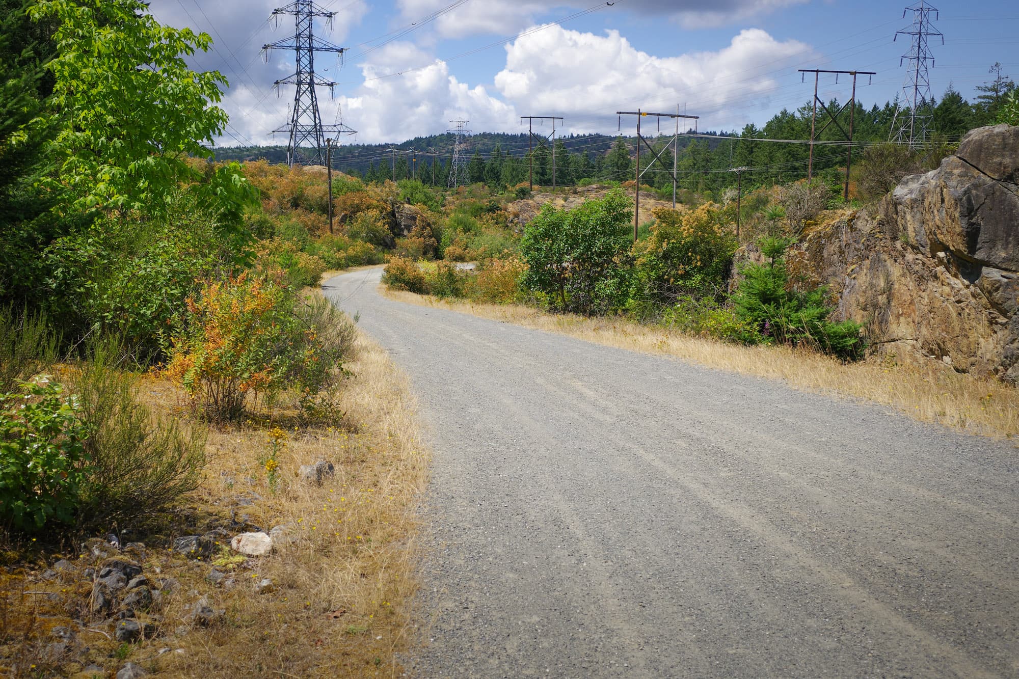 Gravel doubletrack through a rocky hydro corridor