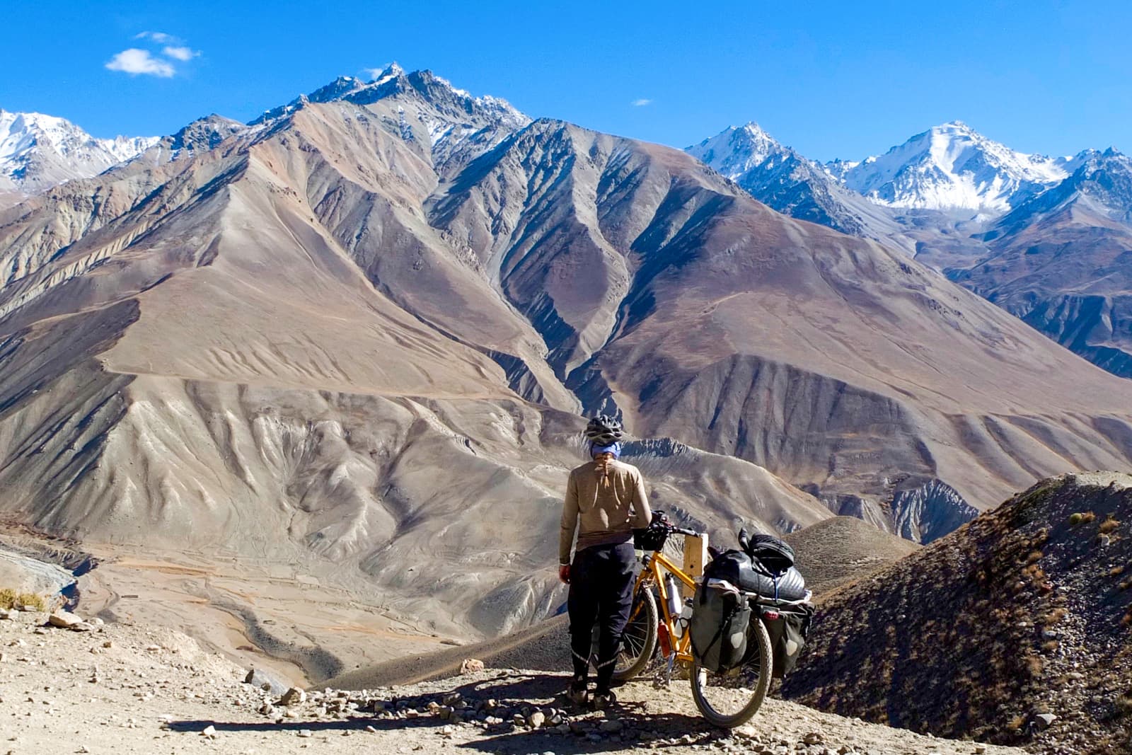 cyclist looking at mountain range
