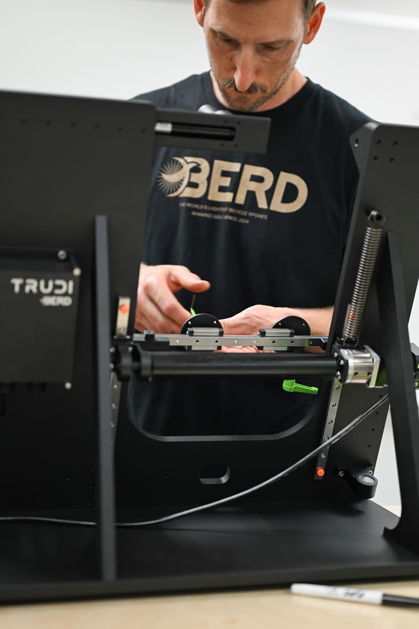 A Berd team member trues a wheel.
