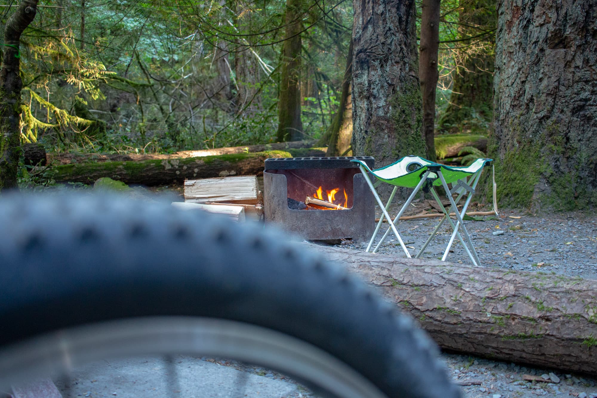 Huxs bike tire in front of a camp fire.