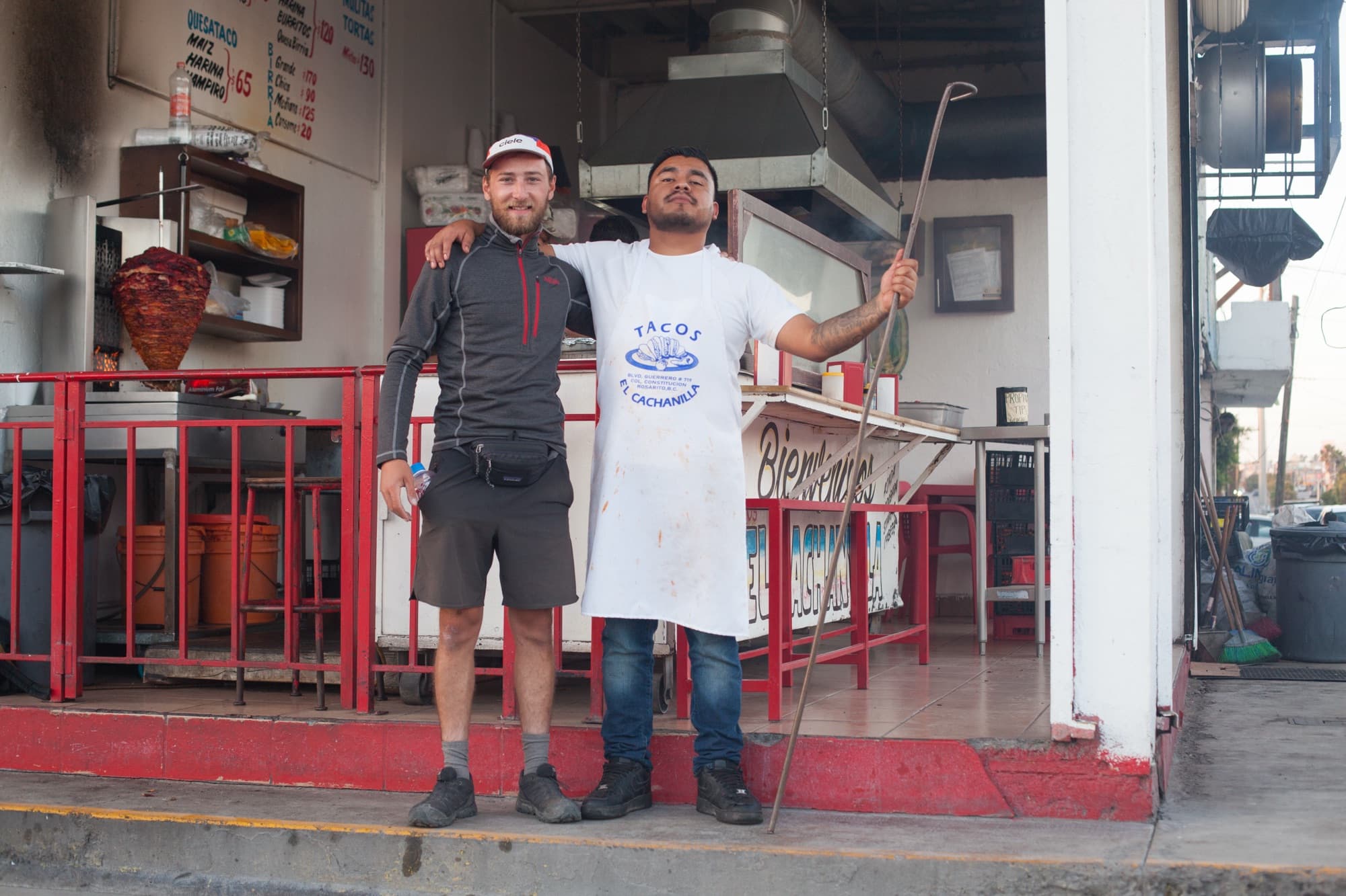 Arm in arm with the cook at a taco stand