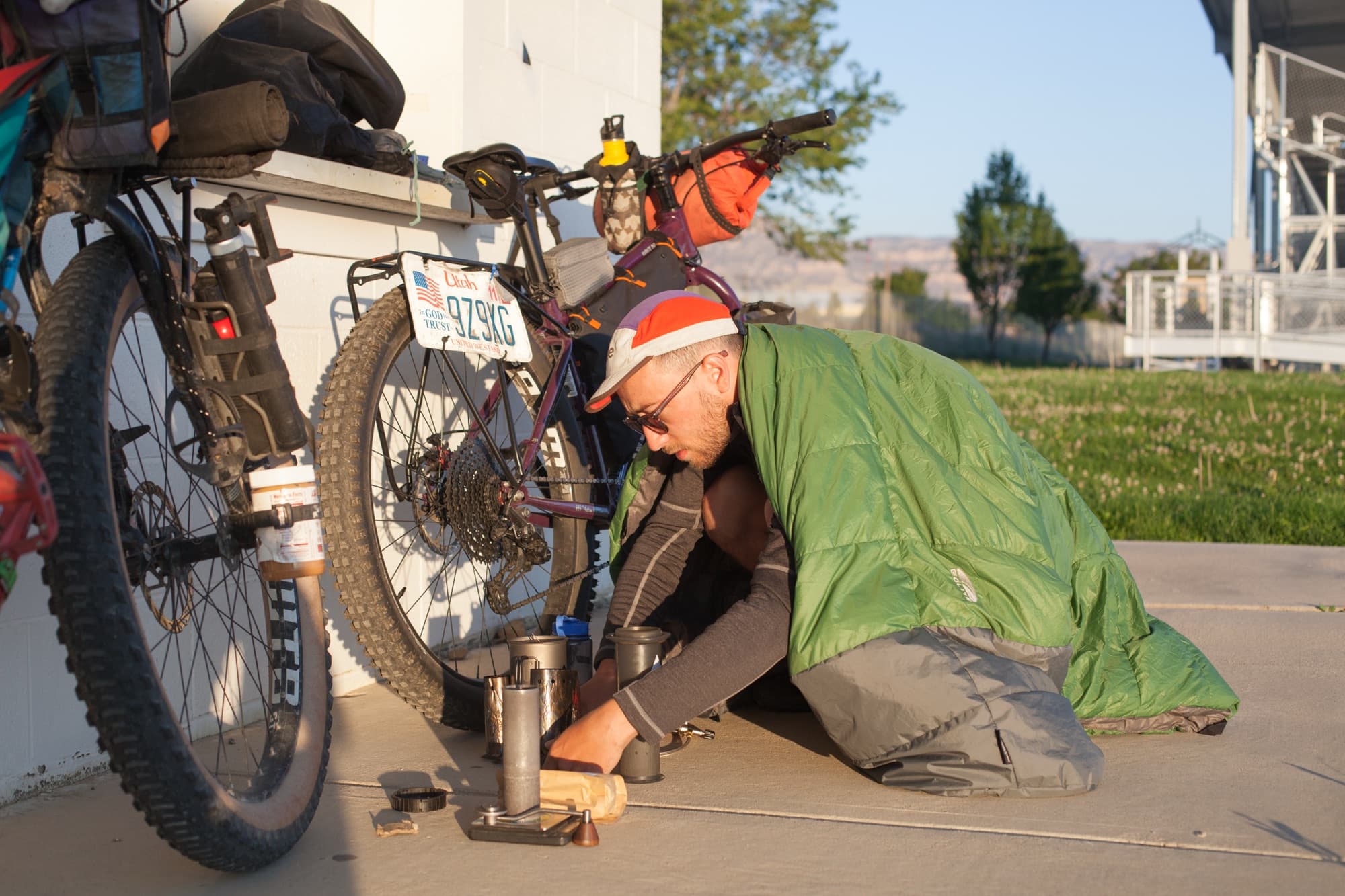 Rebuilding the bike at dawn, sleeping bag still over the shoulders