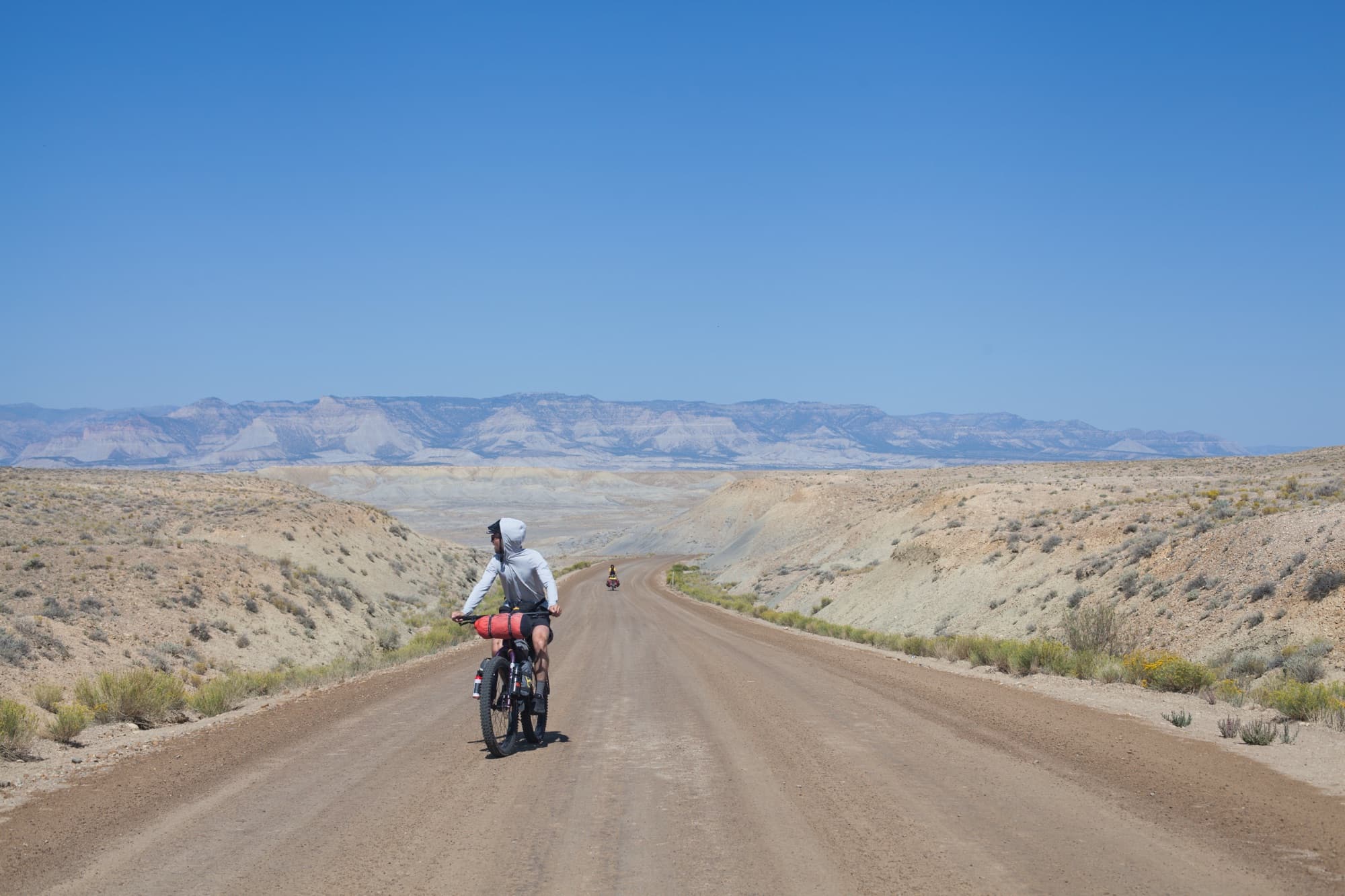 Riding a long straight gravel road through the Utah desert