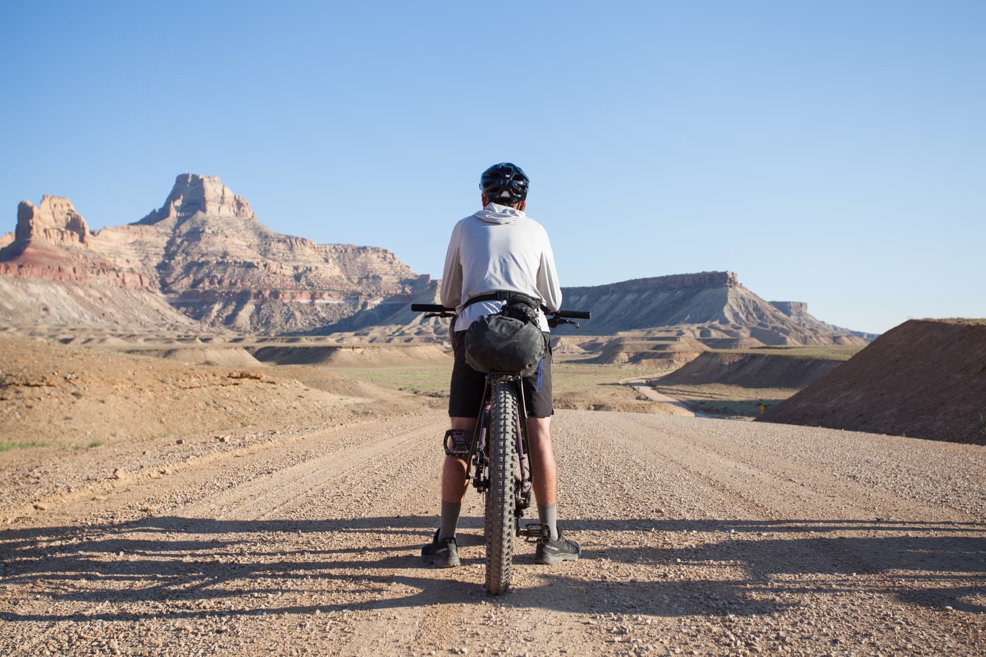 Straddling a loaded bike, facing the mesas of the San Rafael country