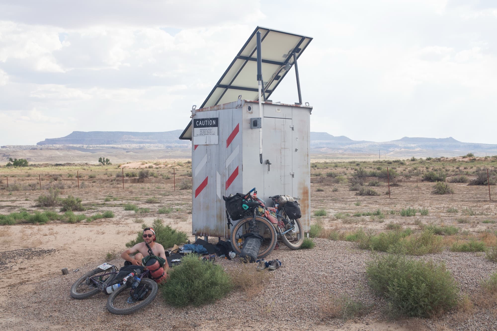 Resting in the shade of a solar-powered outpost in the open desert