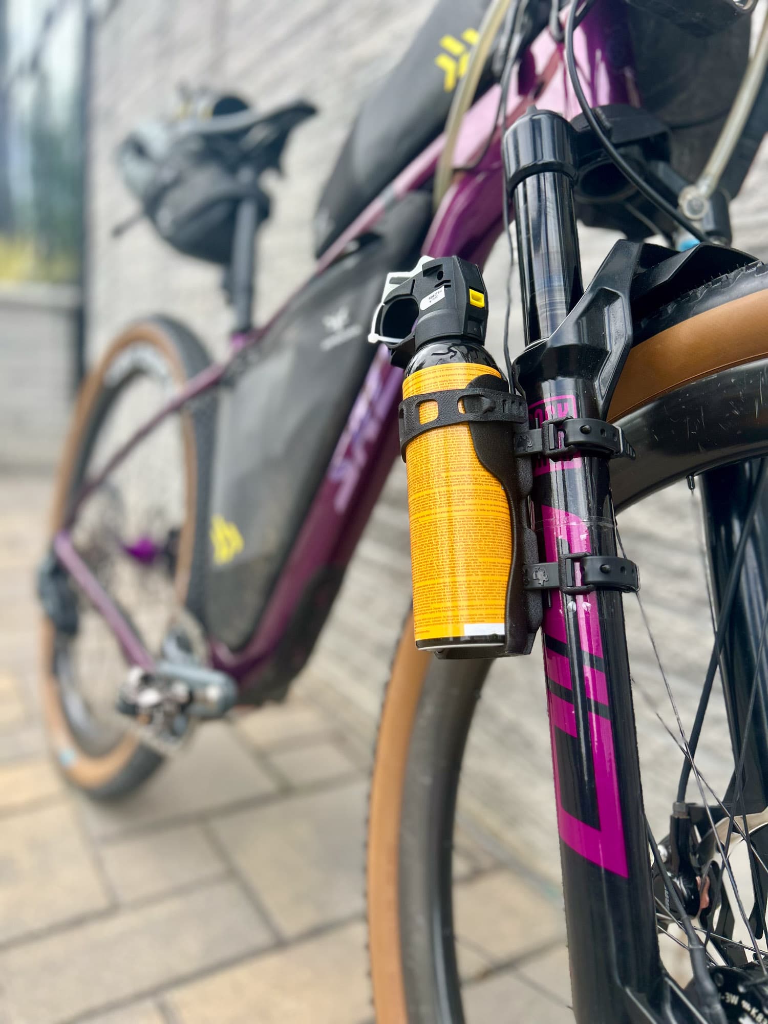 The Cutthroat's suspension fork and tan Rene Herse tire.