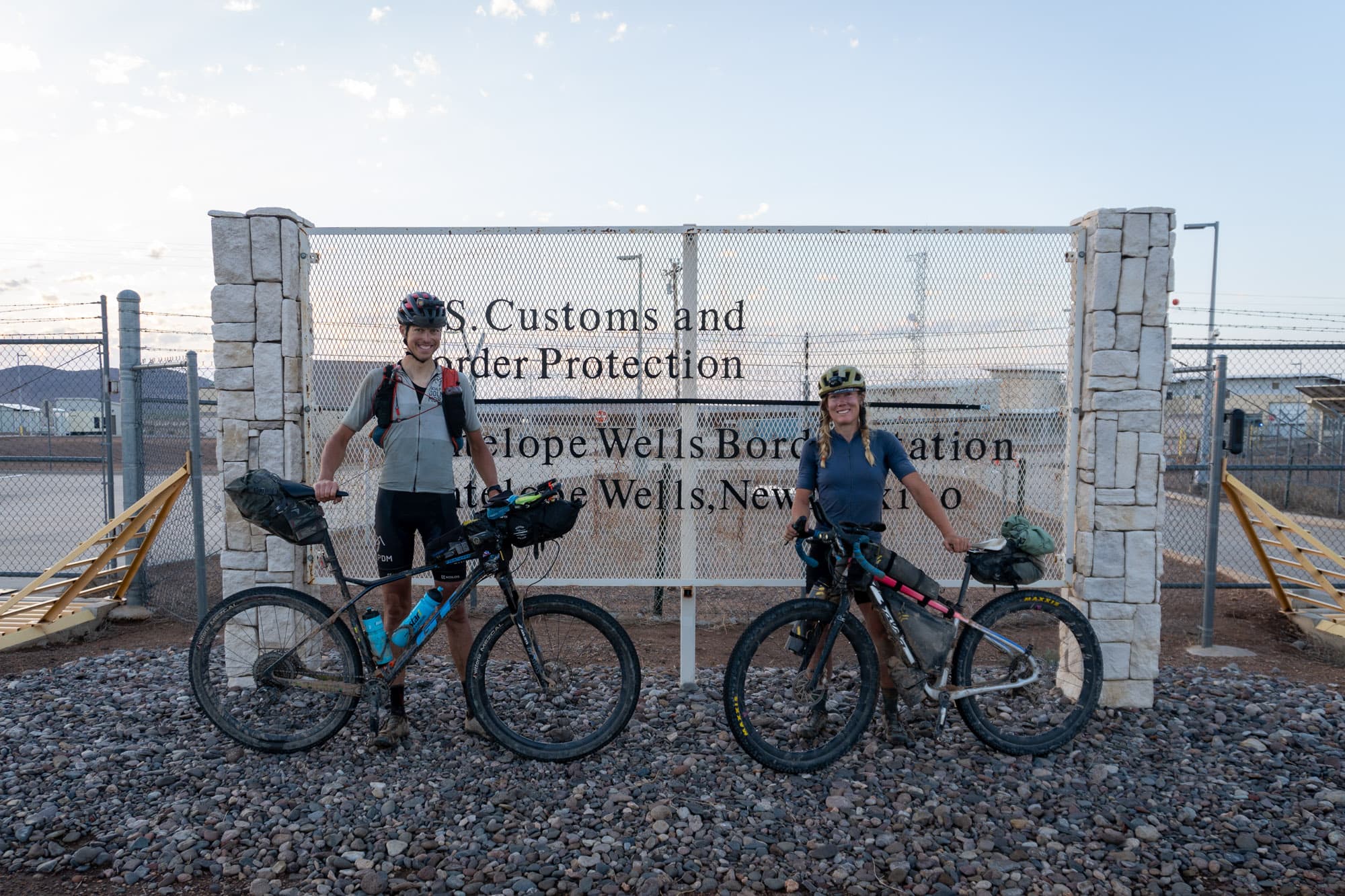 Two riders and their bikes at the Antelope Wells border station in New Mexico.