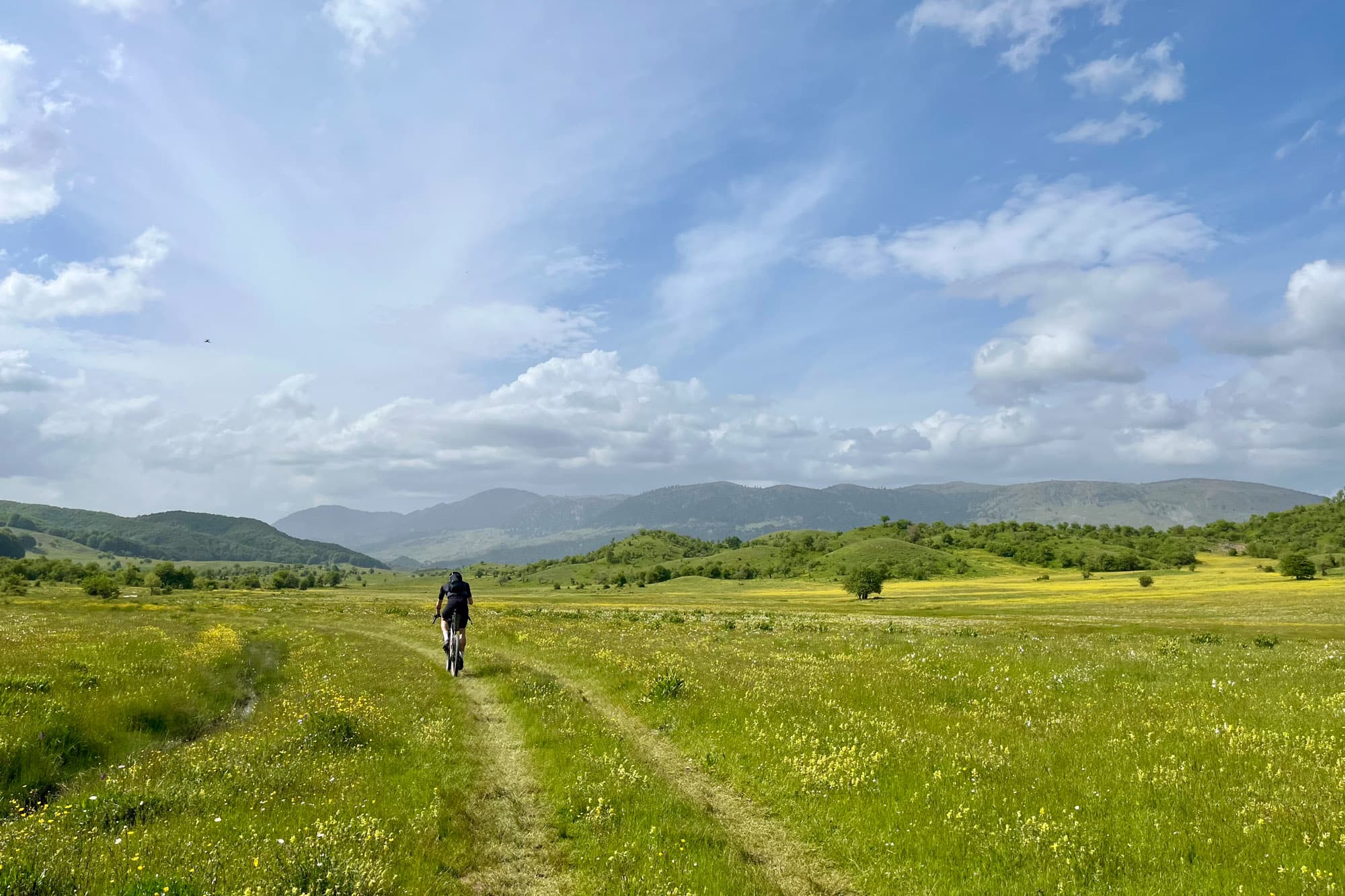 A racer cycles through a field in Greece.