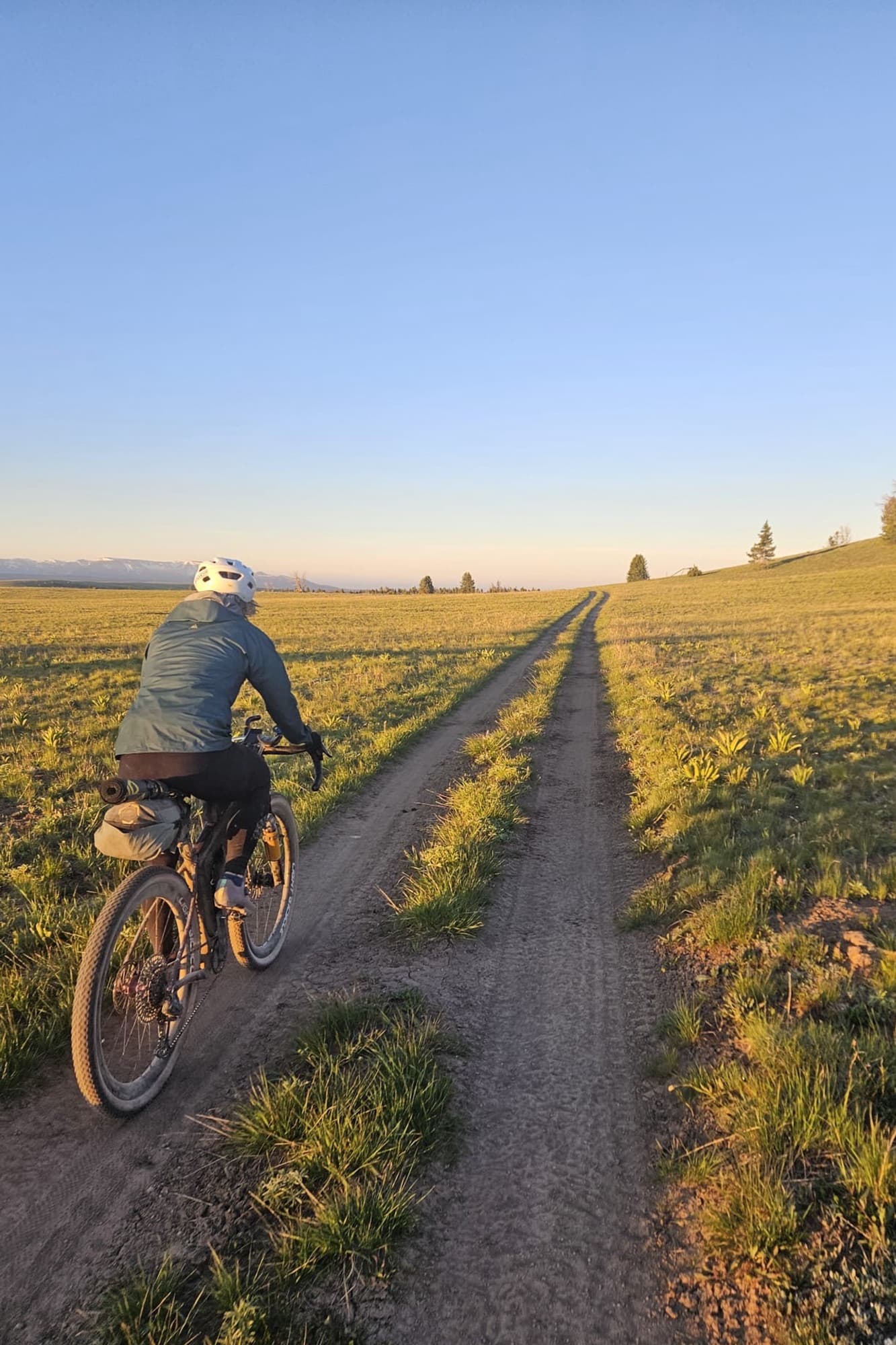 Golden-hour riding on a two-track across open rangeland