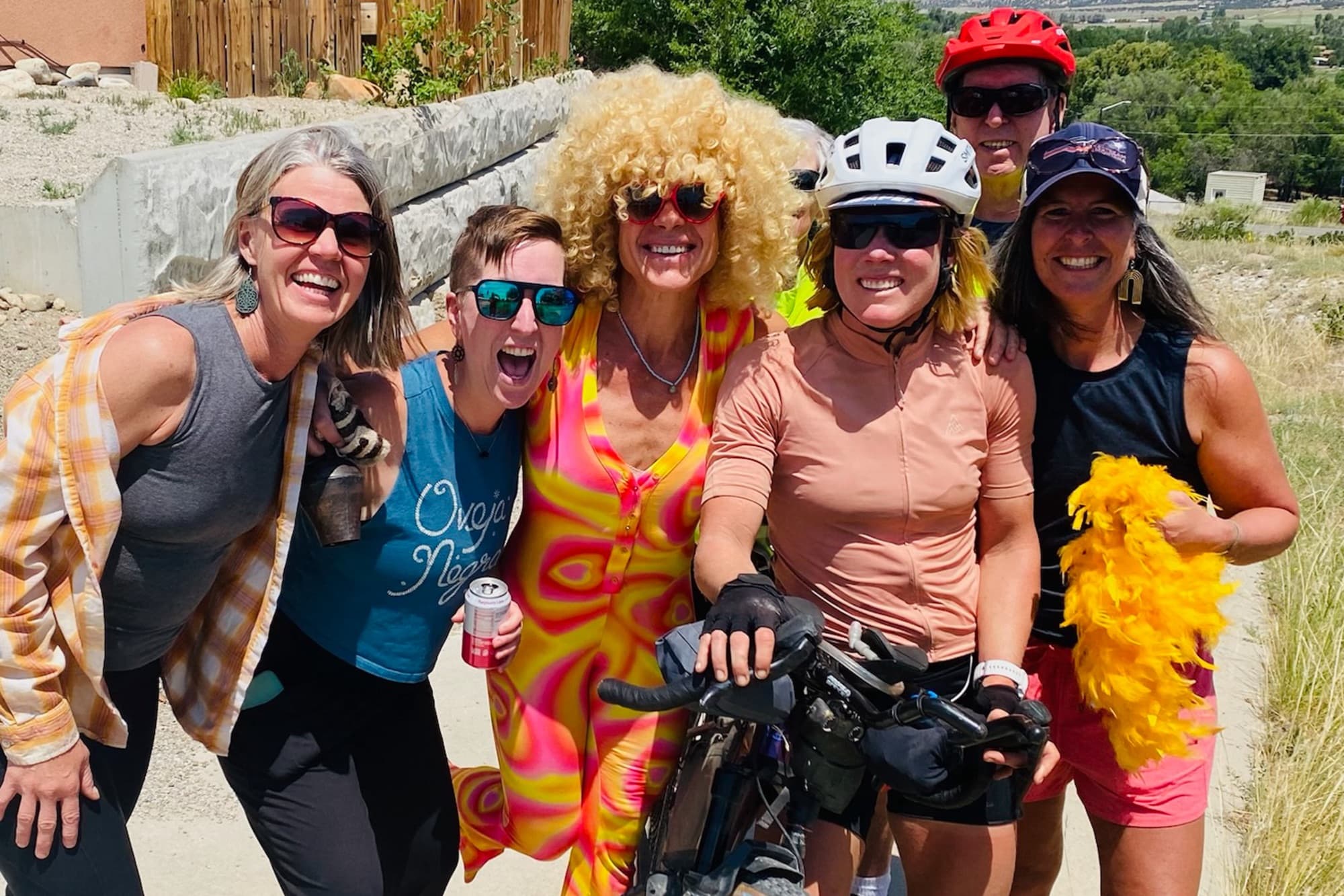 A costumed welcome party celebrates with Meaghan along the route