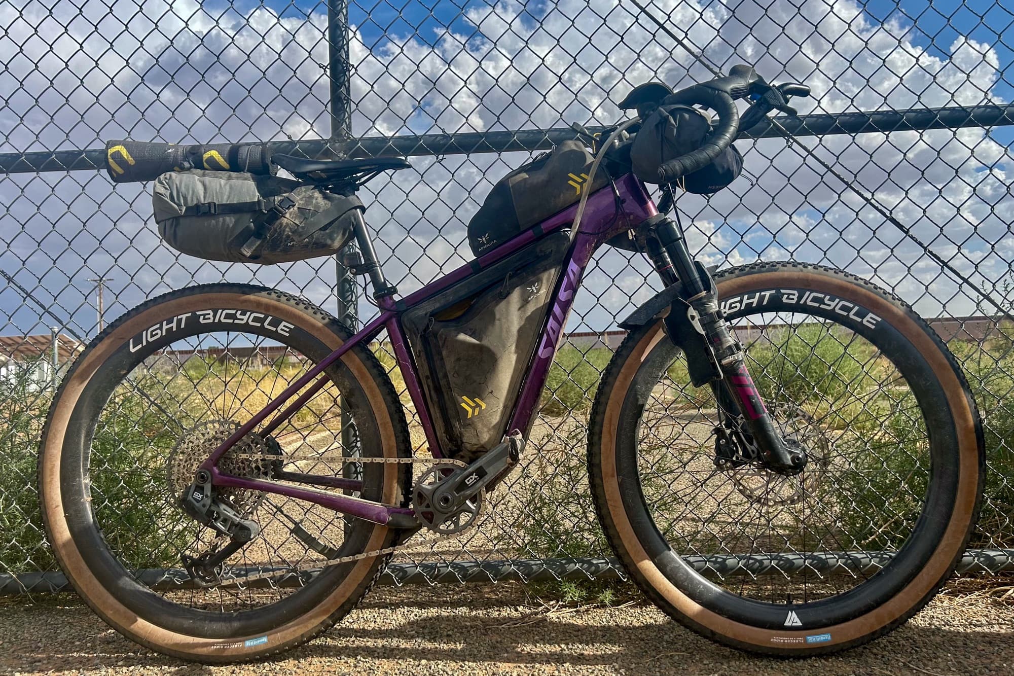 Dolly the Salsa Cutthroat leans on the border fence at Antelope Wells